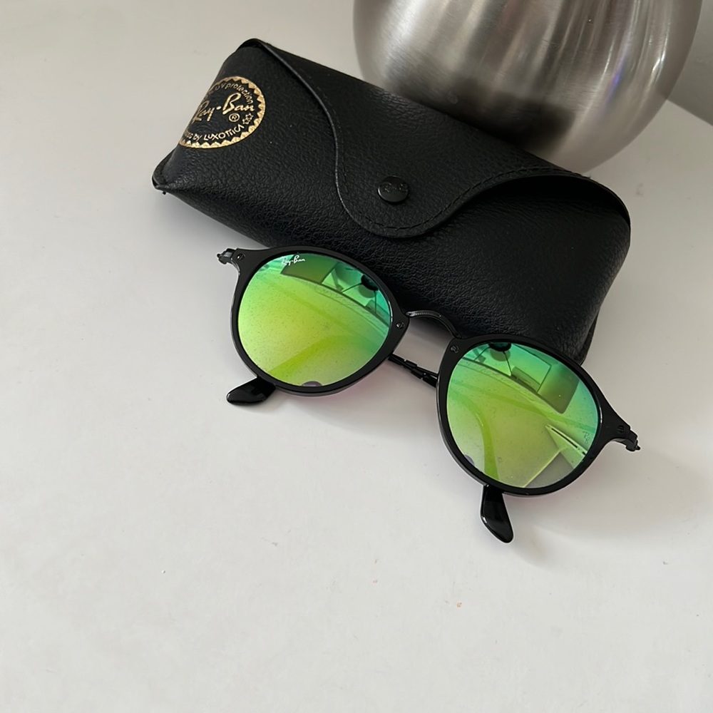 Black frames with green mirrored lenses